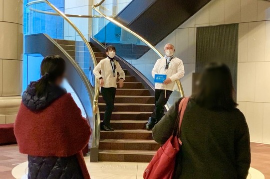 Guides posing on the stairs in the lobby